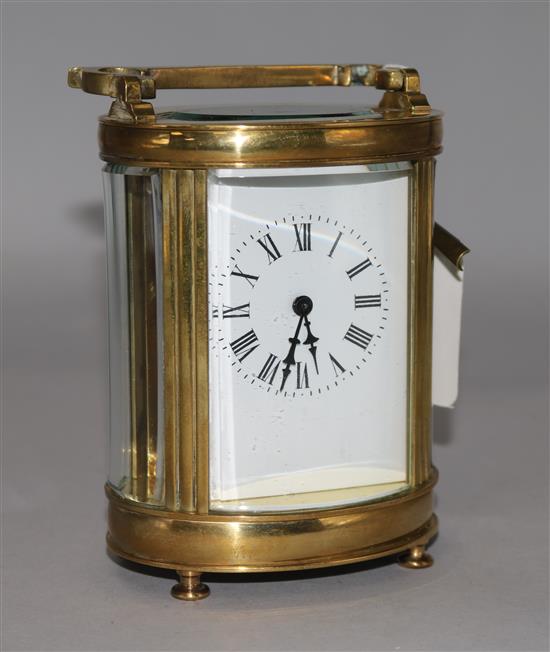 A late 19th century French brass oval cased eight day carriage timepiece